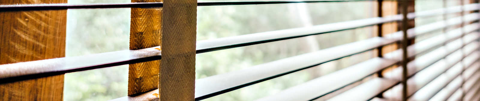 Modern horizontal window blinds installed on residential window with natural light